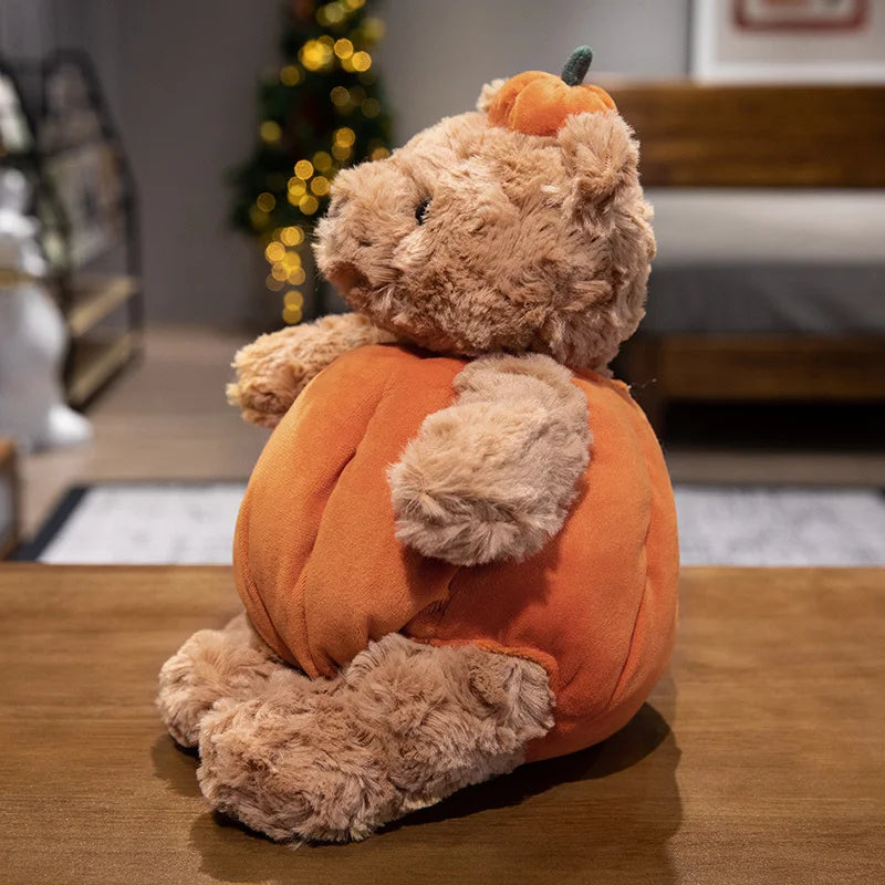 Adorable plush toy featuring a cute bear nestled inside a vibrant pumpkin, perfect for adding a cozy, festive touch to your Halloween decor.