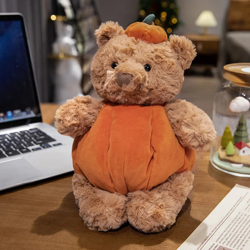 Adorable plush toy featuring a cute bear nestled inside a vibrant pumpkin, perfect for adding a cozy, festive touch to your Halloween decor