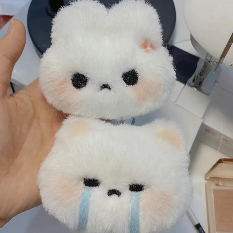 Cute plush cat keychain duo, perfect for accessorizing bags and keys with adorable expressions