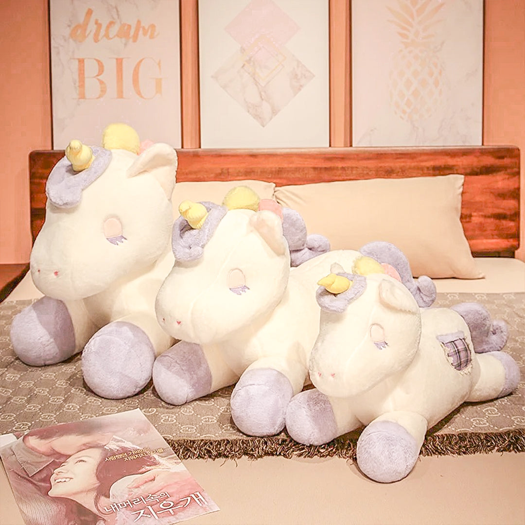 A cozy gigantic unicorn plush toy nestled among pillows, symbolizing comfort and a world of magical dreams.