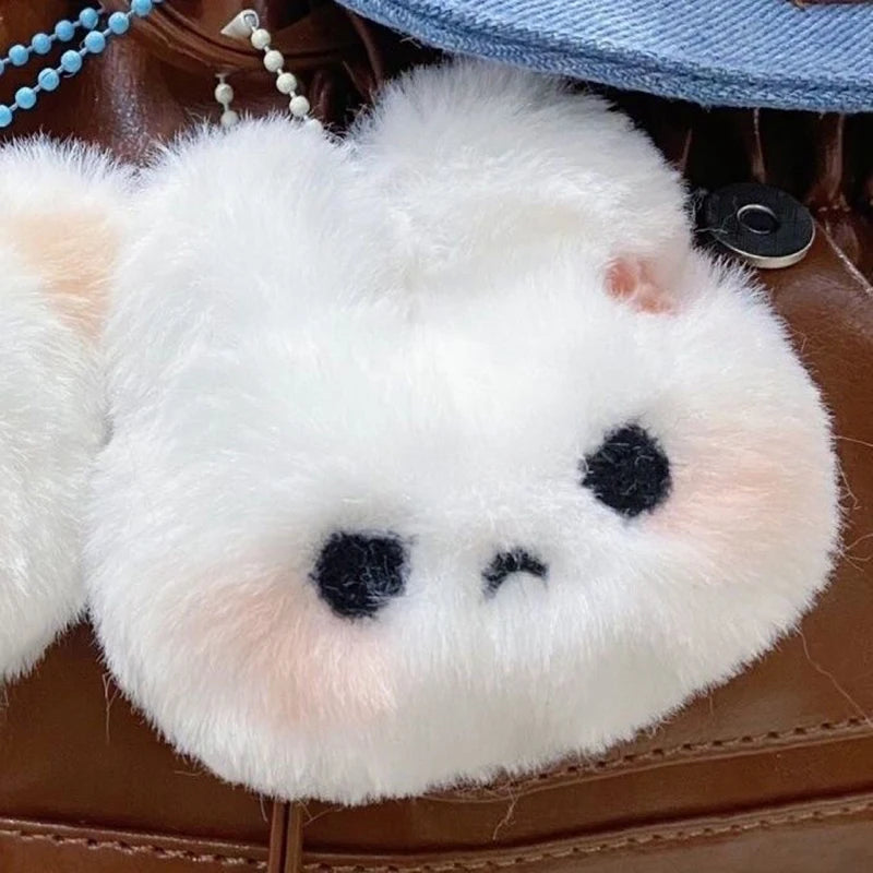 Soft and fluffy crying and grumpy cat plush keychains attached to a bag, ideal kawaii accessories